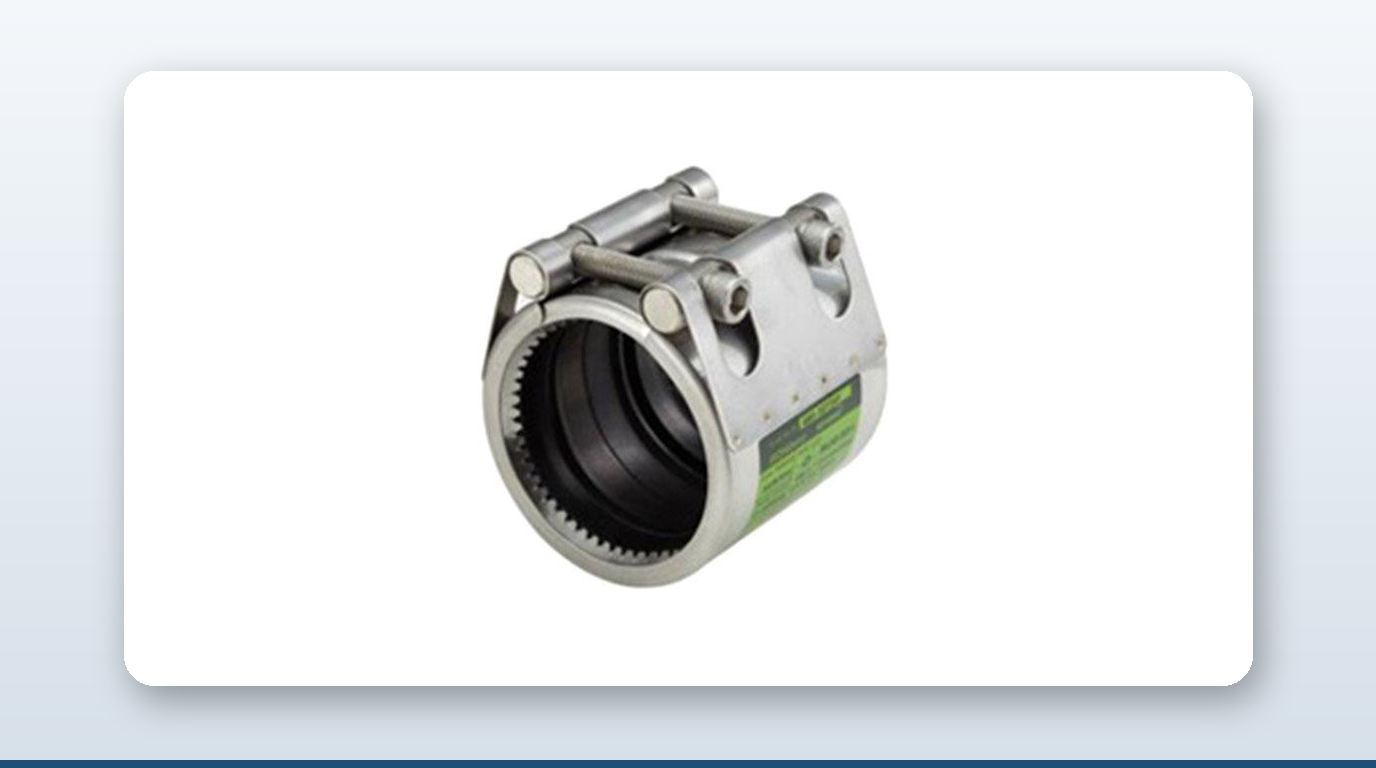 Stainless-steel DN100 pipe coupling clamped around a 114.3mm carbon-steel pipe end on a workbench