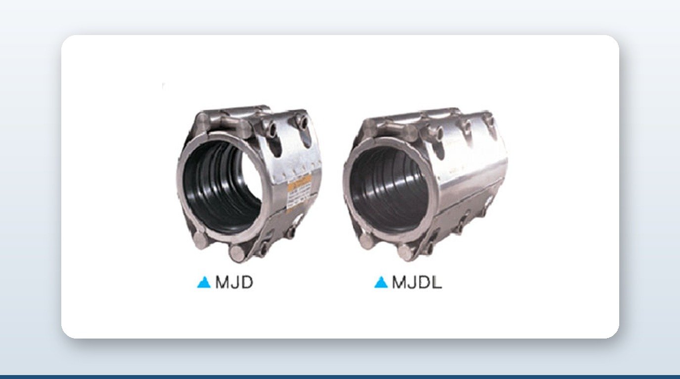 A pipe coupling and a flexible coupling beside a cutaway section of pre-insulated pipe showing its steel, foam, and HDPE layers